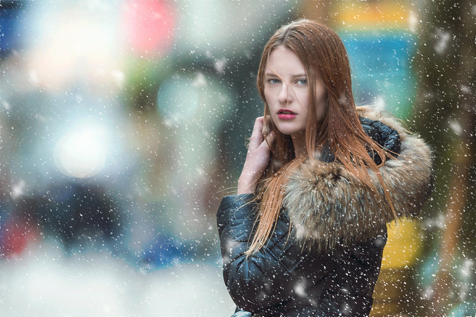 Woman looks over shoulder through snowfall